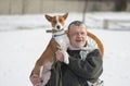 Portrait of basenji dog on the hands of Caucasian senior man. Royalty Free Stock Photo