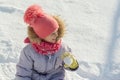 Winter outdoor portrait of child girl smiling and playing with snow, bright sunny winter day Royalty Free Stock Photo