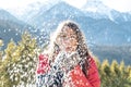Winter outdoor portrait of cute positive young girl blowing snow and having fun Royalty Free Stock Photo