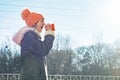 Winter outdoor portrait of young girl screaming in a megaphone paper cup, copy space