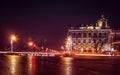 Winter Palace Hermitage and quay at crossroads at night in St. Petersburg