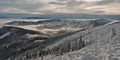 Winter panorama of Beskids mountains with only highest hills above misty level
