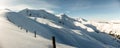 Winter panorama with fence posts and fresh powder of the ridge leading to the Hochwang peak near Chur Royalty Free Stock Photo