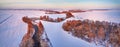 Winter panorama. Snow covered fields, meadows. River, frozen trees, village in evening light. Rural sunset landscape. Dirt road in Royalty Free Stock Photo