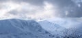 Winter panoramic. Landscape of high mountains with snow white peak. Forest. Lawn covered with snow. Evergreen trees in the Royalty Free Stock Photo