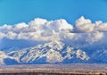 Winter Panoramic view of Snow capped Wasatch Front Rocky Mountains, Great Salt Lake Valley and Cloudscape from the Bacchus Highway Royalty Free Stock Photo