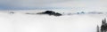 Winter Panoramic View to snow covered mountains above the clouds of inversion fog. View from Riedberger Horn in Allgau Royalty Free Stock Photo