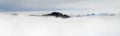 Winter Panoramic View to snow covered mountains above the clouds of inversion fog. View from Riedberger Horn in Allgau Royalty Free Stock Photo