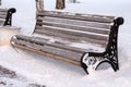 Winter Park covered with snow is a lonely bench on which no one sits Royalty Free Stock Photo