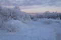 Winter Park. Frozen river, snow-covered trees, power lines and poles. Sunset, polar night. City in the Far North . Royalty Free Stock Photo