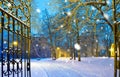 winter park with gateway in the snowfall by night, Town of Postoloprty, Czech Republic Royalty Free Stock Photo