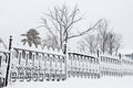 Winter park landscape. metal fence covered in snow