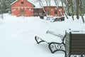 Winter in the park. Lonely benches standing in the snow, selective focus