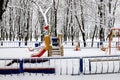 Winter park square with children s playground, covered with snow. Children s slides and swings in winter. Dnipro, Dnipropetrovsk, Royalty Free Stock Photo