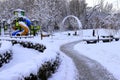Winter park square street with children s playground, covered with snow. Children\'s slides and swings in winter Royalty Free Stock Photo