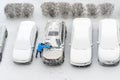 Winter parking lot cars under snow covered cars snow clearing. Parked cars snow removal. Cover winter yard above view