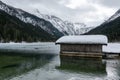 Lake Jagersee in winter with snow and wooden hut. Royalty Free Stock Photo