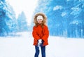 Winter and people concept - cheerful child having fun in winter