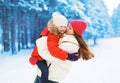 Winter and people concept - positive mother and child having fun