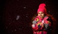 Winter, people, happiness concept - woman in hat, muffler and gloves on dark