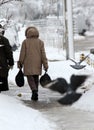 Winter. People walk on a very snowy sidewalk. People step on an snow-stray pathway. Icy sidewalk. Ice on sidewalks Royalty Free Stock Photo