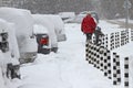 Winter. People walk on a very snowy sidewalk and road. People step on an icy pathway, icy sidewalk. Uncleaned streets and roads