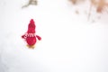 Winter photo with Christmas decorations for pine tree. Knitted snowman toy girl standing on the ski in the forest. Happy holidays Royalty Free Stock Photo