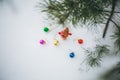 Winter photo with Christmas decorations for pine tree. Knitted snowman toy girl standing on the ski in the forest. Happy holidays Royalty Free Stock Photo