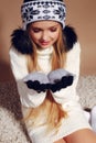 Winter photo of cute little girl with long blond hair wearing a hat and gloves Royalty Free Stock Photo