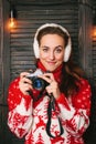 Winter photographer girl in red sweater with dears Royalty Free Stock Photo