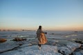 Winter photoshoot woman on the shore of the Gulf of Finland in St. Petersburg