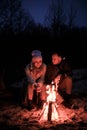 Winter picnic on baech with bonfire. Love story on winter foggy sand beach. fry marshmallows at the stake Royalty Free Stock Photo