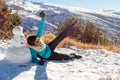 Winter Playtime Latina Woman Having Fun Next to Snowman in Snowy Scene Royalty Free Stock Photo