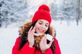 Winter portrait of a beautiful woman with facial cream and snowflake on winter background. Face skin care in winter Royalty Free Stock Photo