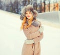 Winter portrait beautiful woman wearing a coat jacket hat over snow Royalty Free Stock Photo