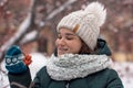 Winter portrait of a charming young woman with freckles on her face. Cute girl looking at the camera on a background of