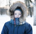 Winter portrait of a child in the hood with fur