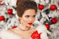 Winter portrait of Elegant woman with ruby jewelry set and red gloves. Beautiful brunette lady with wedding hairstyle, beauty Royalty Free Stock Photo