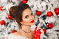 Winter portrait of Elegant woman with ruby jewelry set and red gloves. Beautiful brunette lady with wedding hairstyle, beauty Royalty Free Stock Photo