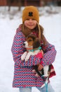 Winter portrait of a girl holding a beagle puppy Royalty Free Stock Photo