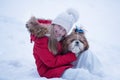 Winter portrait of a girl with a Shih Tzu dog
