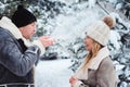 winter portrait of happy couple playing, blowing snow and spending good day outdoor in snowy forest Royalty Free Stock Photo