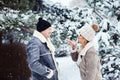 winter portrait of happy couple playing, blowing snow and spending good day outdoor Royalty Free Stock Photo