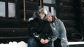 winter portrait. Happy, funny couple in love, man and woman, dressed in warm winter clothes, fully covered with Royalty Free Stock Photo