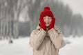 Winter portrait of happy girl on snowy nature background. Young woman in fashionable winter clothes on walk Royalty Free Stock Photo