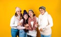 Winter portrait of happy latin family three generations of hispanic women on yellow background in Mexico Latin America Royalty Free Stock Photo