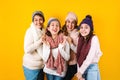 Winter portrait of happy latin family three generations of hispanic women on yellow background in Mexico Latin America Royalty Free Stock Photo