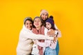 Winter portrait of happy latin family three generations of hispanic women on yellow background in Mexico Latin America Royalty Free Stock Photo