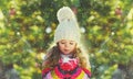 Winter happy little girl child blowing snowflakes from her hands outdoors on snowy background Royalty Free Stock Photo