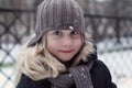 Winter portrait of happy little girl wearing knitted hat, scarf and coat Royalty Free Stock Photo